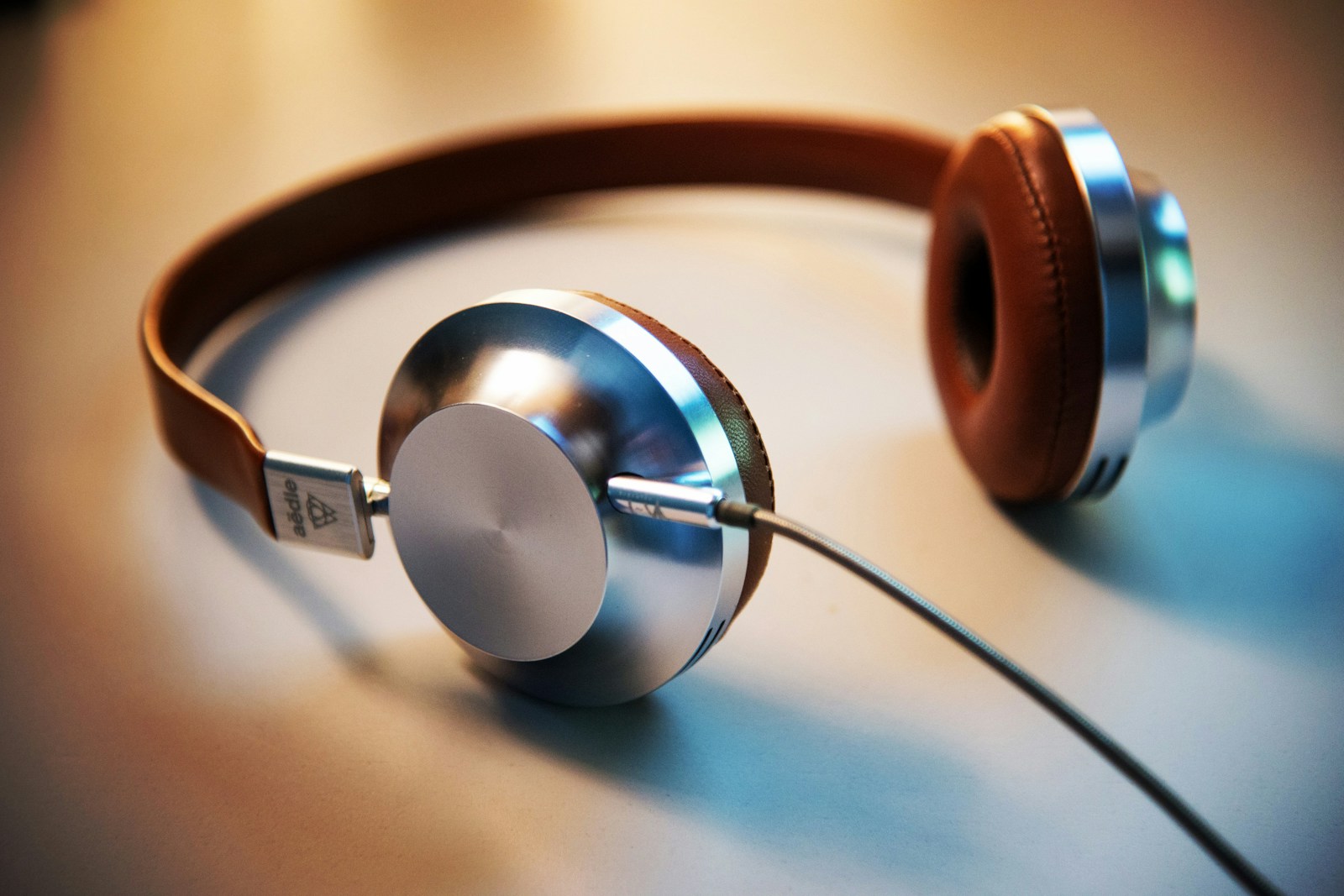 Headphones resting on a desk beside a pencil and notepad, for focused subtitle checking